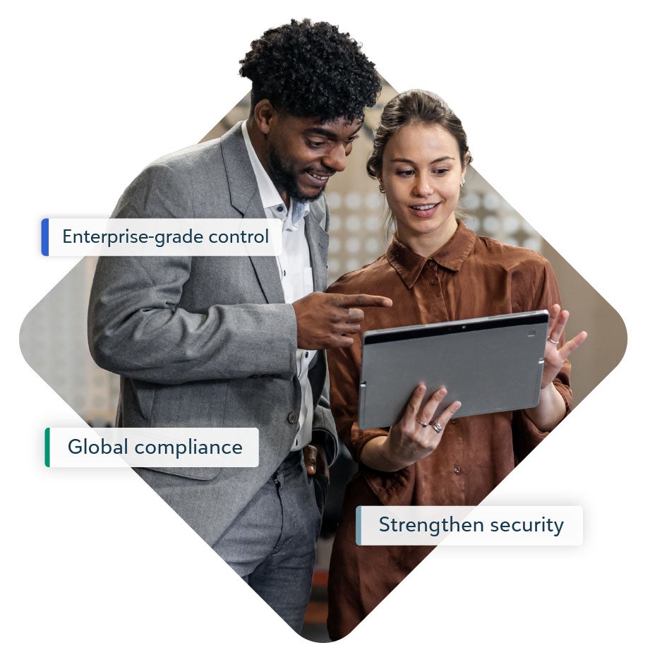 A business woman holding up a laptop to a businessman, with floating text around them on 